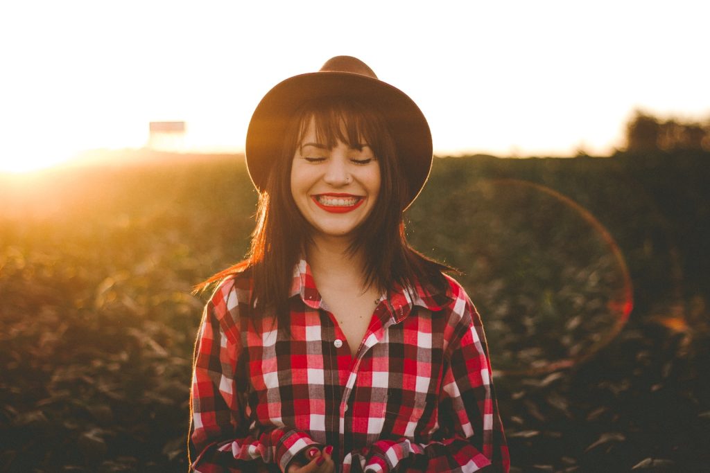 Smiling woman with glowing, healthy skin after cosmetic acupuncture treatment.