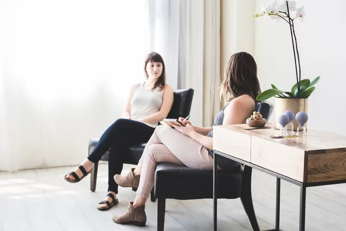 A practitioner consulting with a patient in a calm, natural setting, symbolizing personalized, holistic health care.