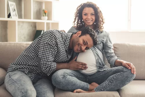 Pregnant couple receiving holistic fertility care at Awaken and Bloom in Salt Lake City