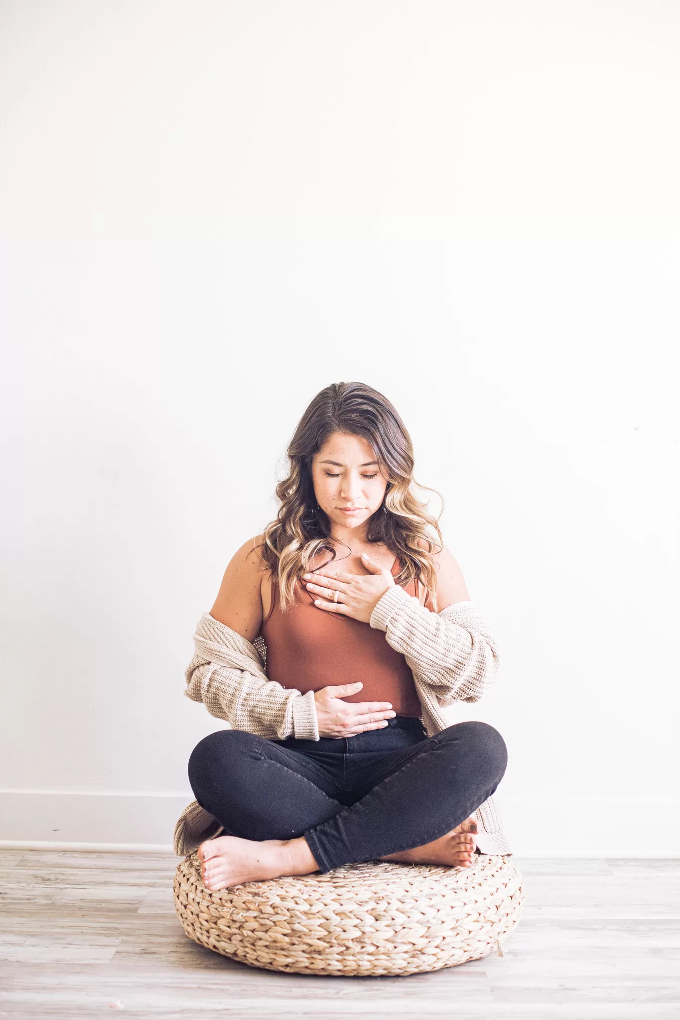 Woman practicing meditation in a serene environment, promoting stress relief and holistic wellness.